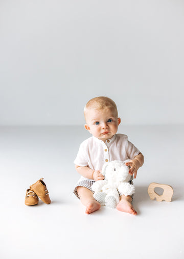baby model with leather shoes and elephant wood teether