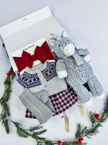 holiday gift set for baby girls with fair isle outfit, red bow headband, and unicorn plushie
