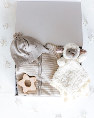 gender neutral gift set with grey onesie and cap, star shaped teething toy, and lamb security blanket
