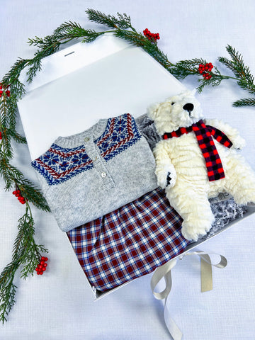 holiday themed baby boy gift box with fair isle sweater, red plaid pants, and polar bear plushie